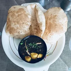 A plate of my homemade Chole Bhature. The bhature are soft and fluffy, served with a side of spicy and tangy black chole, just the way it should be.