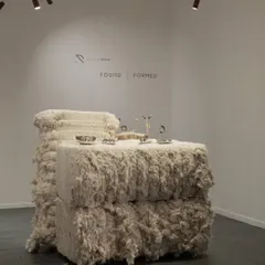 A view of the 'FOUND | FORMED' exhibition space we designed. The raw cotton bales act as display surfaces for the intricate jewelry, creating a unique material dialogue between the found and the formed, the raw and the refined.