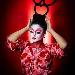A Valentine's Day themed look, complete with heart-shaped hair and creative face paint. This shows the fun and imaginative side of makeup artistry.