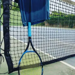 Sweat is gold. This image of a sweat-drenched shirt, a racquet, and a ball on the court captures the essence of our belief in hard work. Every drop of sweat is an investment in your success.