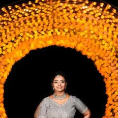 A stunning portrait of the bride framed by a tunnel of golden lights, making her the center of a magical scene.