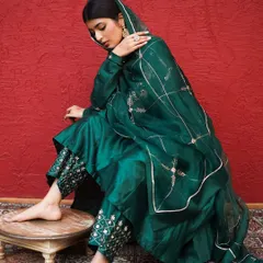 Capturing a moment of quiet elegance. The way the model holds the sheer dupatta highlights its delicate embroidery and the overall grace of this traditional Indian outfit.