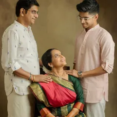 A beautiful family portrait celebrating a 25th wedding anniversary. The love between parents and their son is so evident.