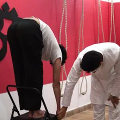 A chair can be your best friend for forward bends if you have tight hamstrings. Here, I am assisting a student in a supported Uttanasana, helping him get a deep spinal stretch without rounding his back.