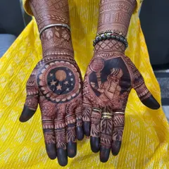 For Karva Chauth, I create designs that tell a story. This one features the classic scene of a wife looking at the moon through a sieve on one palm, and a portrait of her husband on the other, making it deeply personal.