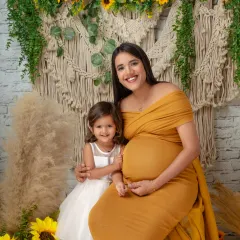 A heartwarming portrait of a mother and her daughter, eagerly awaiting the new baby. Including older siblings is a wonderful way to make them feel part of the journey.