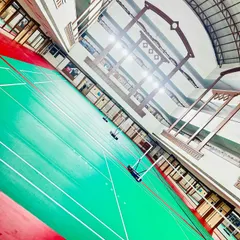 Another perspective of our well-lit, multi-court facility. We have four courts available, allowing for simultaneous group training, drills, and practice matches.