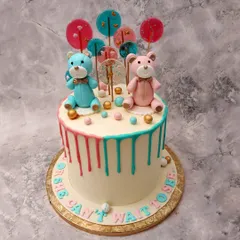 This "He or She, Can't Wait to See" cake features adorable blue and pink teddy bears, colorful lollipops, and a fun drip effect.