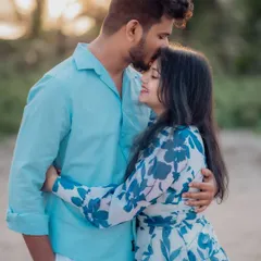 A simple forehead kiss can say so much. This close-up portrait captures a moment of pure tenderness and affection against the soft light of a beach sunset.