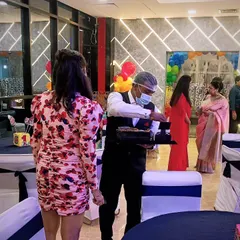 A member of my service team attending to a guest at a party. I believe in proactive and friendly service to make every guest's experience a pleasant one.