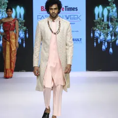 A modern and stylish look from my runway collection. This outfit pairs a simple light pink kurta and pants with a beautifully embroidered longline overcoat, creating a sophisticated Indo-Western ensemble.