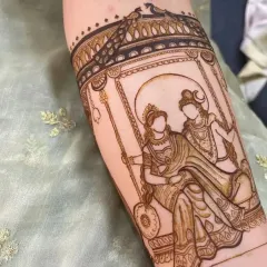 The same Shiva-Parvati design shown during the application process, highlighting the clean linework before the shading is filled in.