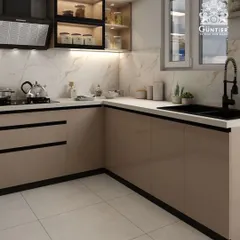 This L-shaped modular kitchen combines beige handleless cabinets with a striking black sink and faucet. The design maximizes corner space while maintaining a clean, modern aesthetic perfect for compact urban homes.