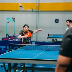 An employee from Gameskraft focuses on her serve during a table tennis match. Our multi sport events give everyone a chance to participate, whether they prefer the fast pace of badminton or the precision of TT.