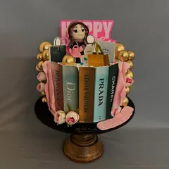 For the ultimate fashion lover, this cake features edible shopping bags from brands like Dior and Louis Vuitton, all propped against edible books. The shopaholic figure on top is also handmade.