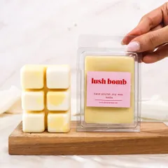 Soothing scents, melting softly. A hand holds up our 'Lush Bomb' wax melt, ready to be used.