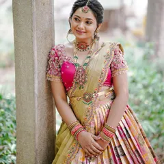 Our client looking graceful and happy during her 'Bhale Shastra' ceremony. The custom-designed half saree, with its vibrant colors and detailed embroidery, complements her traditional jewelry and joyful spirit perfectly.