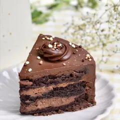 A rich and decadent chocolate cake slice, a perfect example of the simple, delicious cakes we love to bake.
