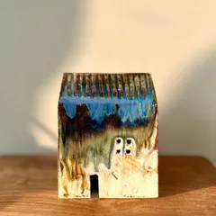 The glaze on this mini house is a stunning mix of blue, brown, and green, showing the beautiful and unpredictable results of high-temperature firing.