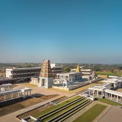 A wide view of the Shiva Temple complex, showcasing the main Gopuram and the expansive courtyard. The design balances the grandeur of traditional temple architecture with serene, open areas for congregation and reflection.