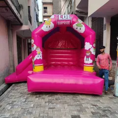 This pink bouncy castle with an "LOL Surprise" theme is a compact combo unit. It features a main jumping area and a small slide on the side.