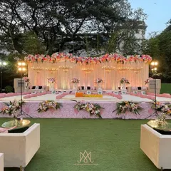 The main stage for the pink-themed Mamera event, featuring a beautiful floral backdrop, elegant chandeliers, and comfortable seating for the family.