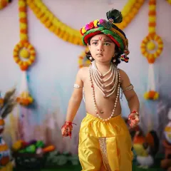 A slightly older child dressed as Krishna, looking majestic in our traditional setup.