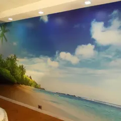 This expansive tropical beach mural instantly creates a relaxing, vacation-like feel. It's a fantastic way to open up a room and provide a calming escape, perfect for waiting rooms or stressful office environments.