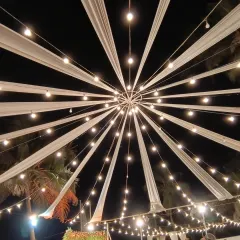 Lighting is key to setting the mood. For this large outdoor event, I designed a dramatic canopy with fabric drapes and string lights radiating from a central point, creating a stunning visual centerpiece that elevated the entire venue.
