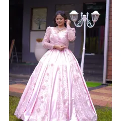 This image showcases the beautiful fit and flow of the pink ball gown. The intricate embroidery on the bodice and skirt adds a touch of sparkle and sophistication, perfect for a fairytale moment.