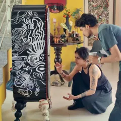 A candid moment of creation. We believe in a hands-on process, and here I am working with my team to meticulously hand-paint a custom sculptural cabinet.