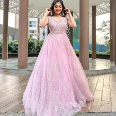 Feel like a princess in this beautiful pink ball gown. The delicate silver embroidery on the bodice and the flowing tulle skirt make it a dream outfit for pre-wedding photoshoots or reception parties.