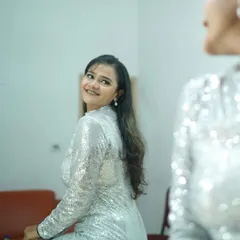 A warm, confident smile in the mirror. This shot captures a moment of self-assurance and is perfect for beauty or fashion lifestyle content.