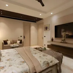 A view from the bed, showing the floating TV unit and the seamless integration of storage and display elements in this timeless master bedroom.