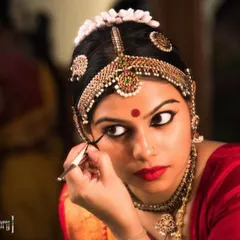 Guru Priya Srinivasan preparing for a performance. The intricate makeup and costume are an integral part of Bharatanatyam, and we ensure our students learn this aspect of the art as well.
