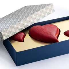 This elegant gift box contains a large, breakable red chocolate heart flanked by two smaller ones, making for a dramatic and delicious Valentine's surprise.
