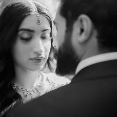 A moment of pure, unspoken connection. This black and white portrait strips away all distractions, focusing solely on the intense and loving gaze shared between the couple. It’s a timeless and artistic shot.