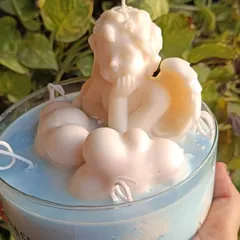 My angel and cloud jar candle is a dreamy, serene piece. It features a sculpted angel resting on fluffy wax clouds, all within a large glass jar with multiple wicks.