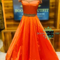 Make a bold statement in this vibrant orange ball gown. The intricate, high-neck beadwork and belted waist create a regal silhouette, making it an ideal rental for sangeets, weddings, or formal gatherings.