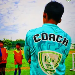 What goes on in a coach's mind? This image captures a coach observing his players, thinking about skill development, character building, and long term growth.