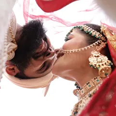 An artistic shot from under the veil, capturing a private kiss. This is the kind of creative wedding photography we love, finding unique angles to tell your love story.