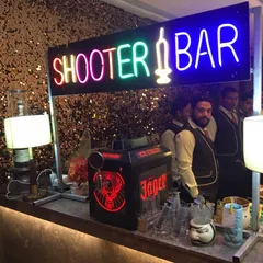 This setup includes our 'Shooter Bar' neon sign and a Jägermeister tap machine, perfect for a high-energy cocktail party or reception.