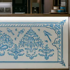 A detail of the hand-painted kitchen counter mural, showing the delicate birds and floral patterns. This close-up reveals the precision and artistry of the craftsmen, whose work brings a personal and rooted story to the heart of the home.