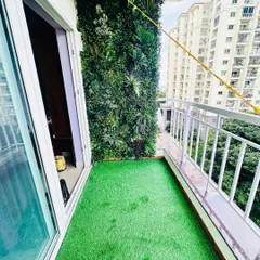 Even a small apartment balcony can become a private green escape. We installed a dense, multi-layered vertical garden and soft artificial grass to completely transform this high-rise space into a cozy, green nook.
