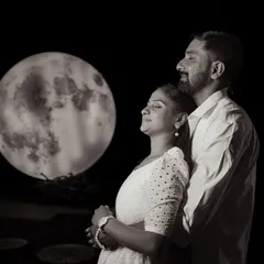 A creative and artistic silhouette shot with a large moon prop. This is a unique concept that results in stunning and memorable pre-wedding photos.