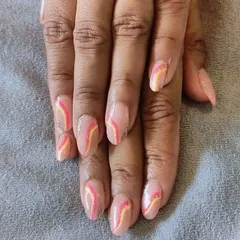 This design features delicate, wavy lines in shades of pink and yellow with a hint of glitter over a nude base. It's a soft and artistic look, perfect for someone wanting subtle nail art.