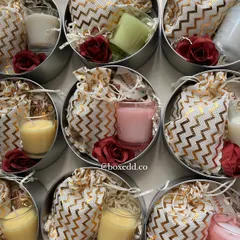 Another view of the contents of the wedding return favours, showing the variety of colorful candles and small gifts.