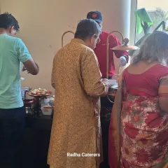 Guests enjoying the buffet at a naming ceremony. My team is trained to be polite and efficient, ensuring the food line moves smoothly and everyone is served well.