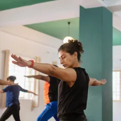A student holds Warrior II with focus and determination. I guide you to find the depth in each posture, exploring the subtle layers of effort and ease that build both physical and mental resilience.