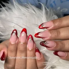 A bold and glossy look. This set features a deep red "jelly" French tip on a clear base, with a silver chrome star for a pop of detail.